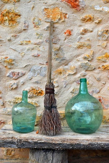 Rustic decoration with glass vases and a briar broom