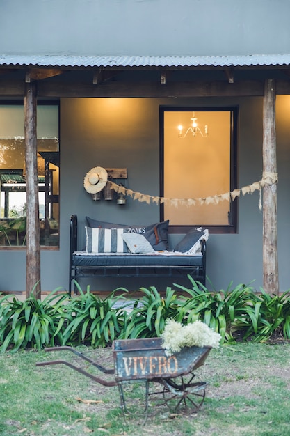 Rustic decorative wheelbarrow in the house garden