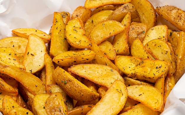 Rustic French fries cut into thicker slices served with herbs and salt