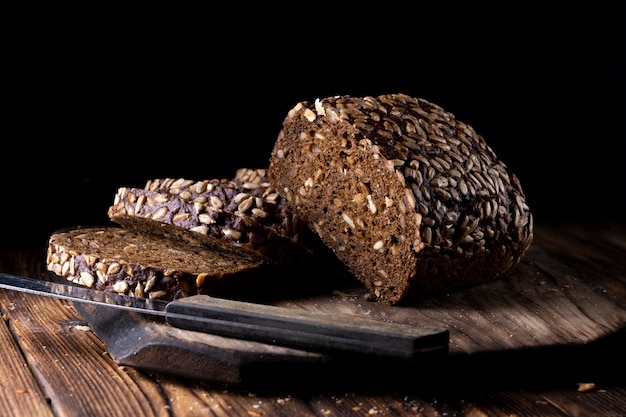 Rustic grain bread with sunflower seeds on a wooden board.