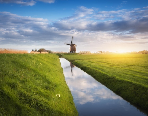 Rustic landscape with dutch windmills near the water canals