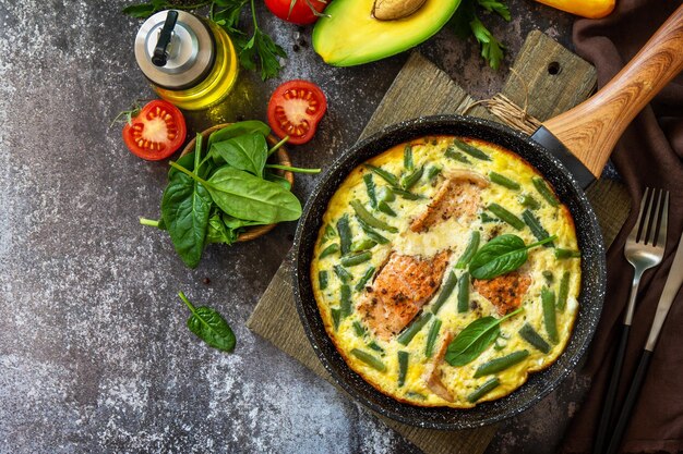 Rustic omelet omelette Scrambled with salmon fillet and green beans Top view flat lay Copy space