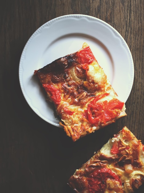 Rustic pizza with salami tomatoes and cheese