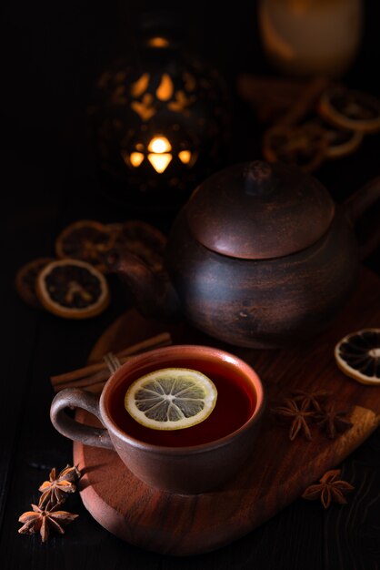 Rustic still life with black tea in a clay cup