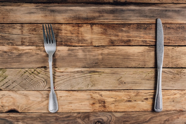 Rustic table setting with silverware on wooden background