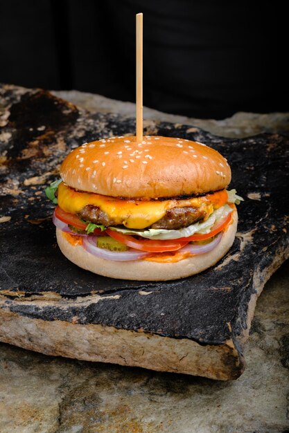 Rustic tasty Burger on Stone Background