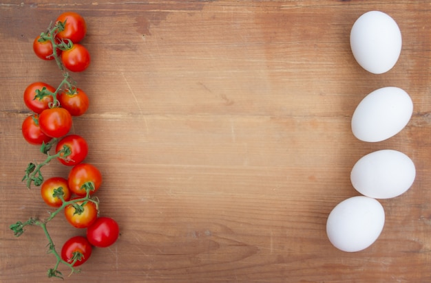 rustic wood background with tomatoes eggs 