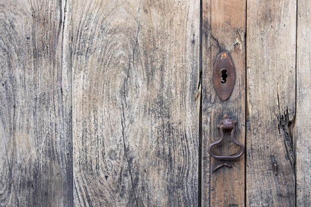 Rustic wood texture with natural pattern as background, Weathered wooden door with keyhole