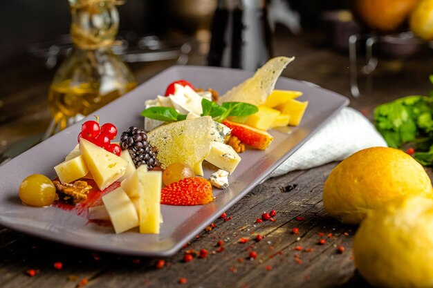 Rustic wooden background, top and side, cheese cutting, fresh herbs, berries, bread