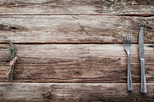 Rustic wooden table with knife and fork