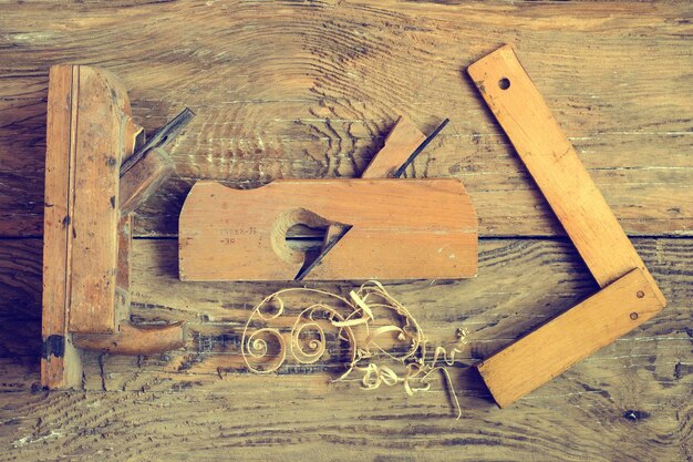 Rustic woodorking tools on old wooden table Top view copy space