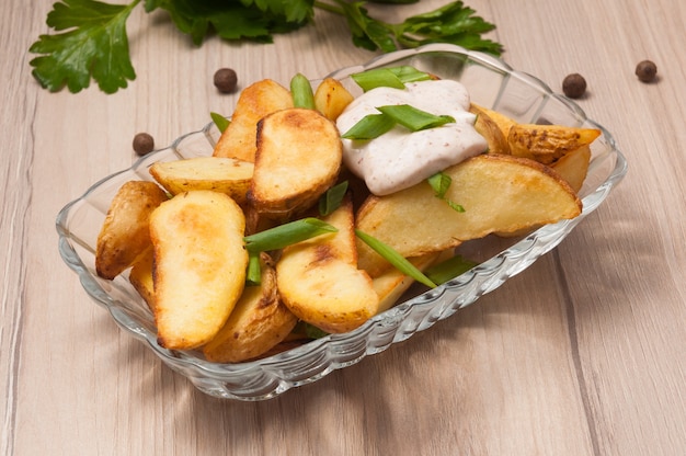 Rustieke aardappelschijfjes met zure room en groene uien