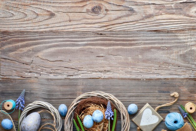 Rustieke Pasen-achtergrond met eieren, blauwe hyacintbloemen en houten hart