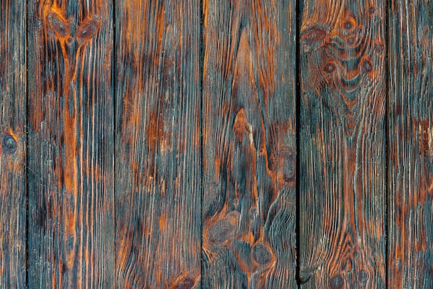 Rustieke teruggewonnen houtstructuur achtergrond. Vintage houten tafel. Rood en zwart oppervlak van oud geknoopt hout