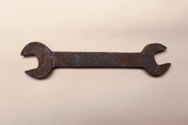 A rusty auto wrench on white background