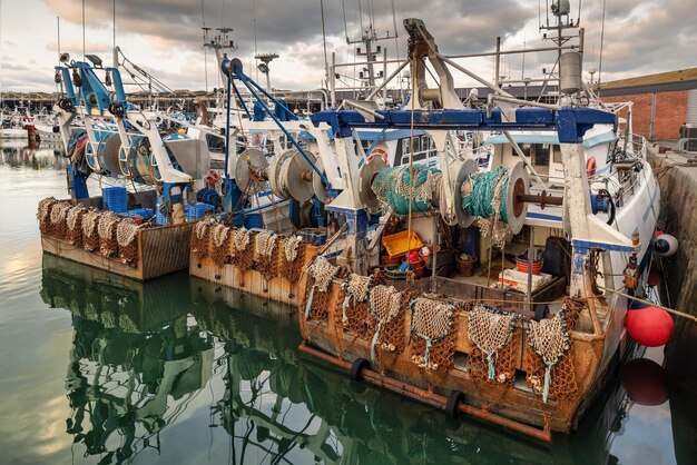 Rusty boats and metal nets for catching scallops