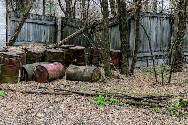 Rusty fuel barrels near the abandoned warehouse at Chernobyl exclusion zone