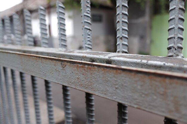 a rusty gray iron fence