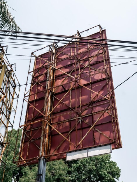 A rusty iron banner on the side of the road