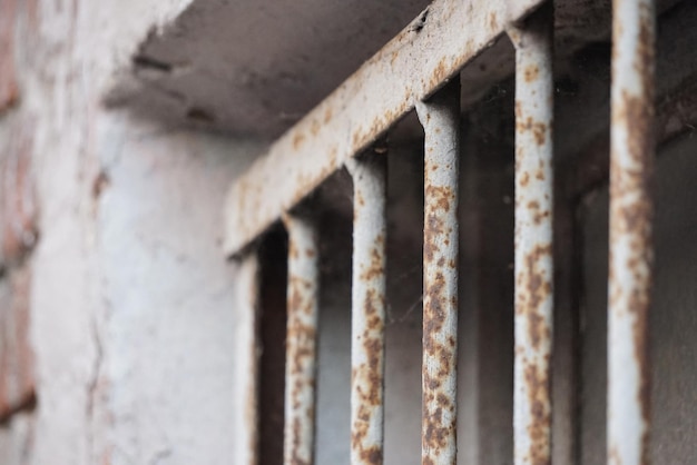 Rusty metal bars near the window