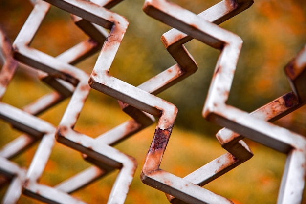 Rusty metal fence made of iron rods, close-up