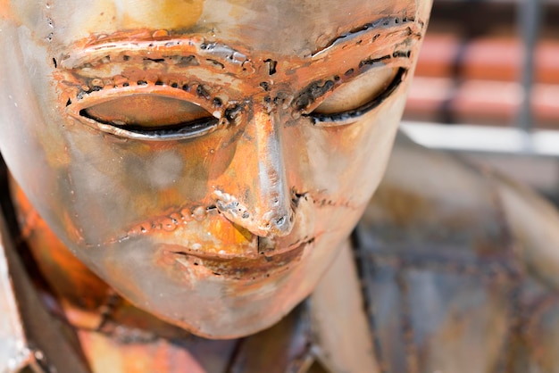 Rusty metal sculpture of a man Head closeup