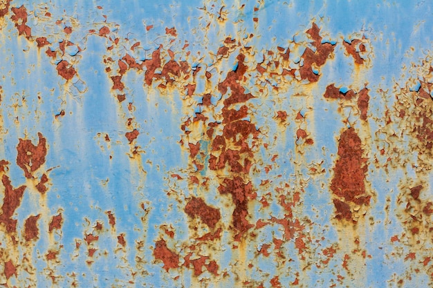 Rusty metal surface with blue cracked paint Old rusty metal Metal covered with rust