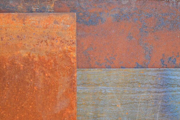 A rusty metal surface with a blue and green stripe