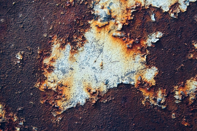 Rusty metal surface with blue paint residue as background image.