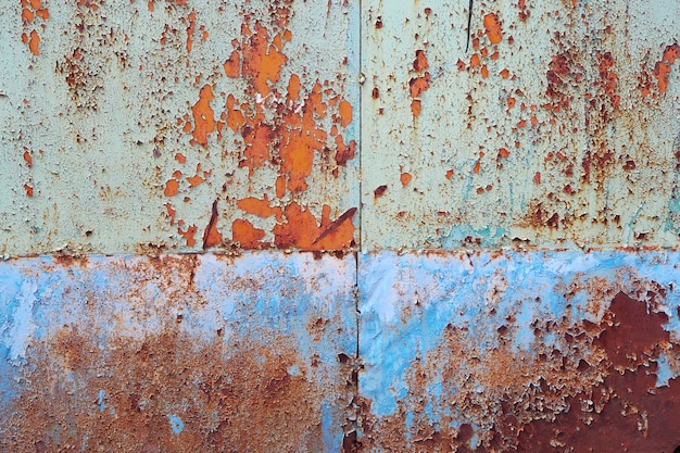 Rusty metal surface with traces of peeling paint