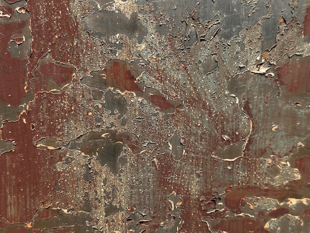 A rusty metal wall with a red background and a black background