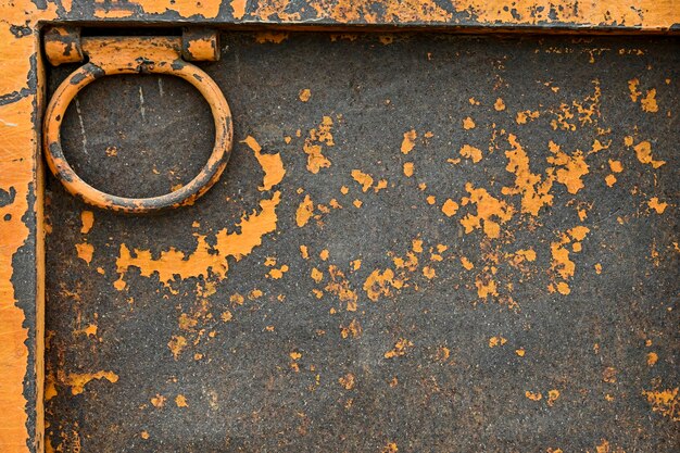 Rusty metallic background with traces of orange paint