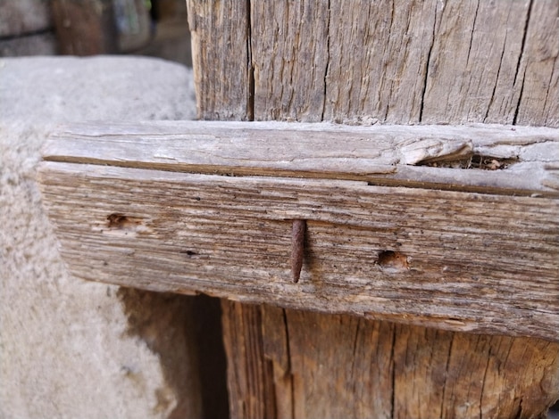 Rusty nail in wood Bent rusty nail in a board from a wooden fence Old wood texture Barn bolt