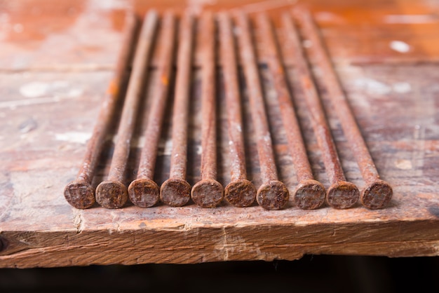 Rusty nails on wooden background
