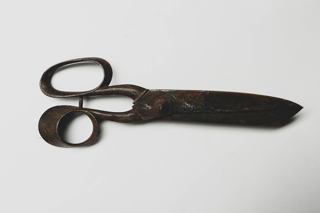 Rusty and old scissors on white background