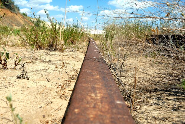 Rusty railway a rail the leader in sandy quarry