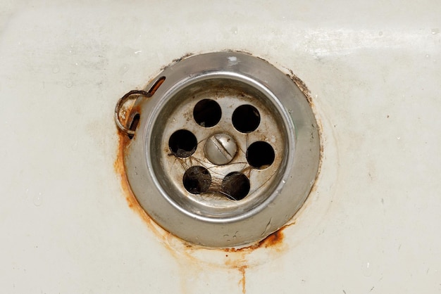 Rusty sink drain in the old bath