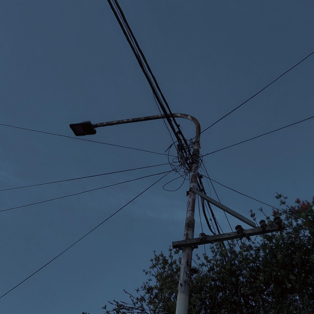 rusty and unlit utility pole, at night