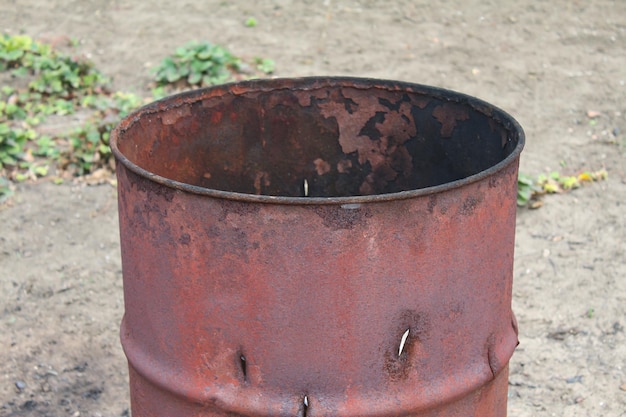 Rusty worn metal barrel selective focus