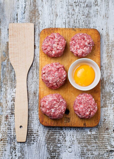 Ruwe gehaktballen op een snijplank