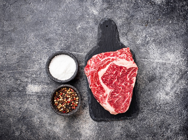 Ruwe gemarmerde ribeye steak en specerijen