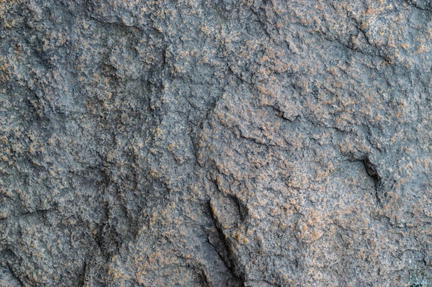 Ruwe grijze granieten rots textuur achtergrond Fragment van natuurstenen muur