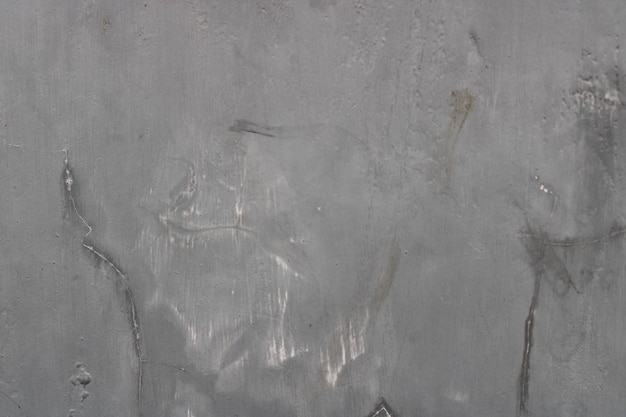 Ruwe textuur van een oude grijze gebarsten muur aan de muur