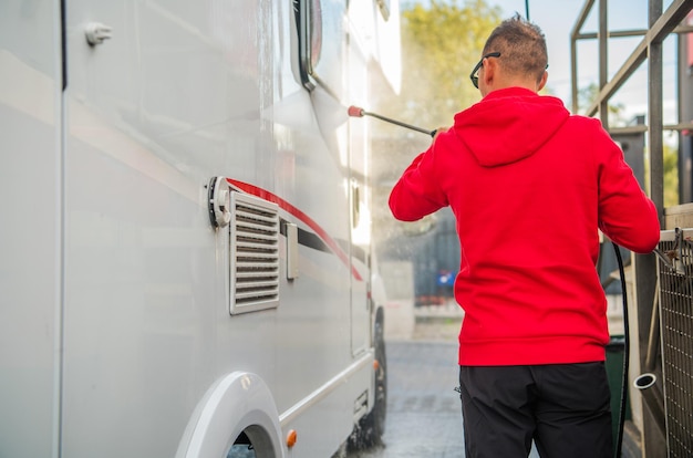 RV Owner Pressure Washing His Camper Van