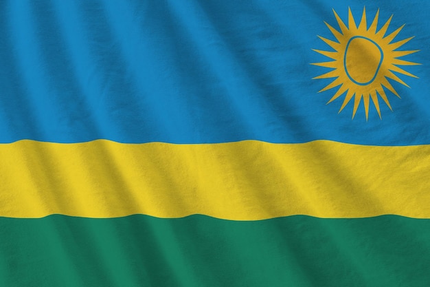 Rwanda flag with big folds waving close up under the studio light indoors the official symbols and c