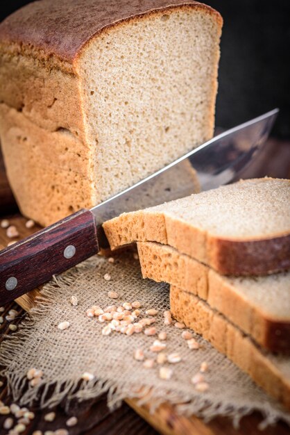 Rye bran bread on dark wooden table