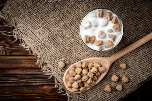 Rye bran and kefir on dark wooden table.