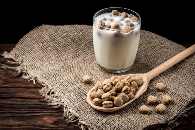 Rye bran and kefir on dark wooden table.