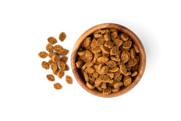 Rye bread crackers in wooden bowl isolated on white background.