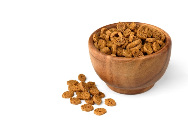 Rye bread crackers in wooden bowl isolated on white background.